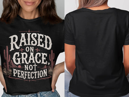 Black t-shirt with text "RAISED ON GRACE, NOT PERFECTION" and desert scene.