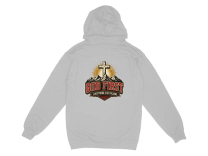 Grey hoodie with a graphic of a cross, sunburst, mountains, and text "GOD FIRST EVERYTHING ELSE FOLLOWS".