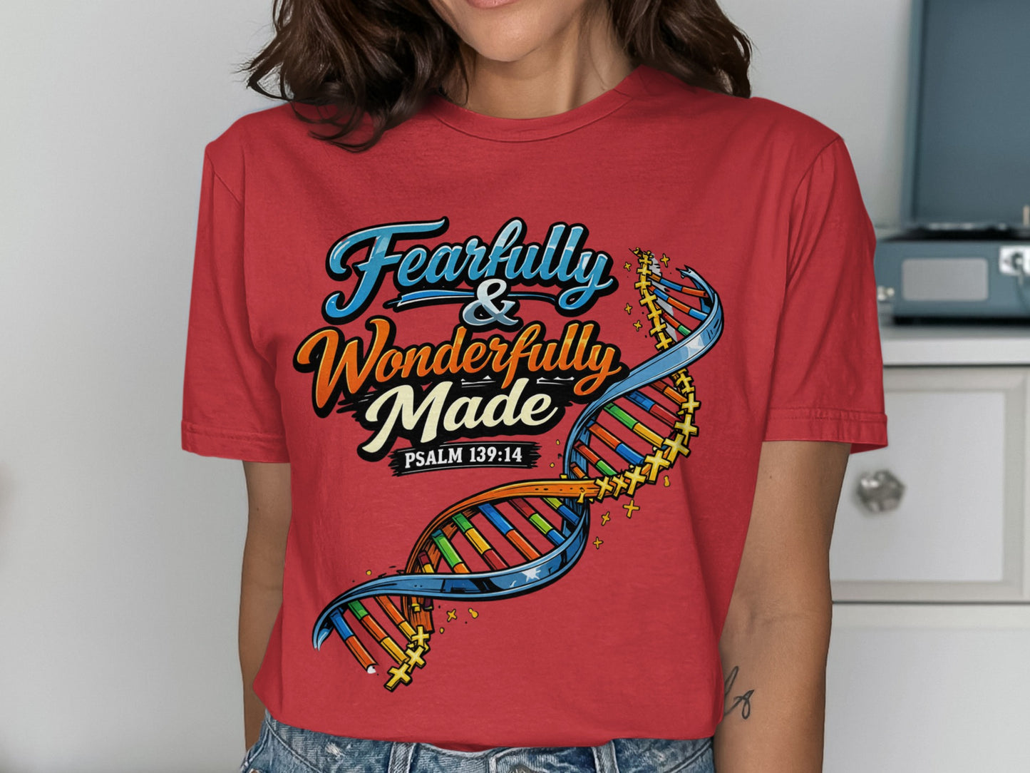 Red t-shirt with "Fearfully & Wonderfully Made Psalm 139:14" and DNA strand graphic.