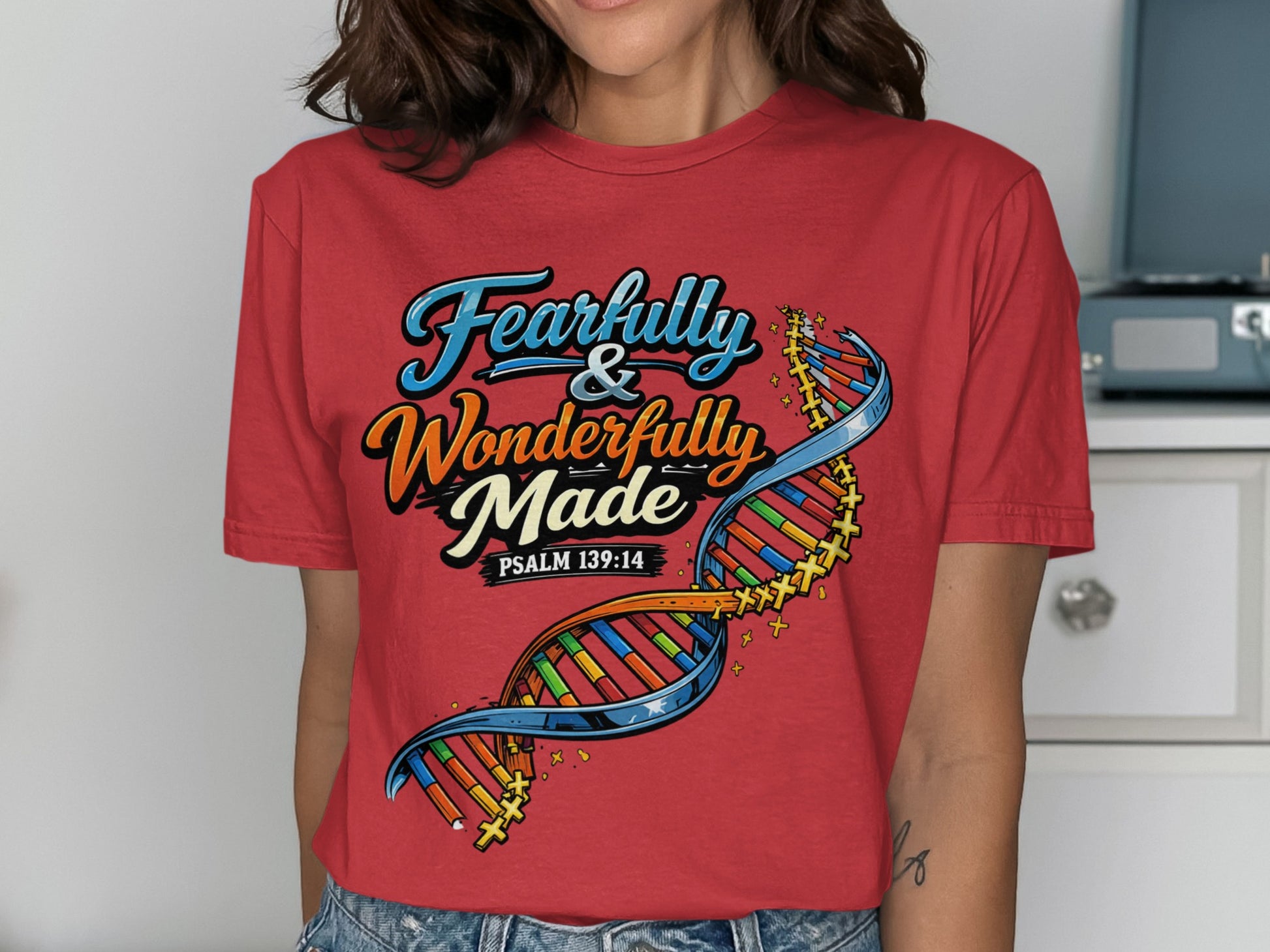 Red t-shirt with "Fearfully & Wonderfully Made Psalm 139:14" and DNA strand graphic.