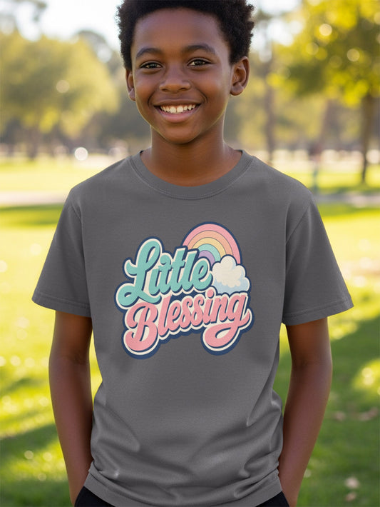 Boy wearing gray t-shirt with "Little Blessing" text and rainbow graphic.