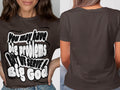 Brown t-shirt with text "You may have big problems BUT WE SERVE A Big God."