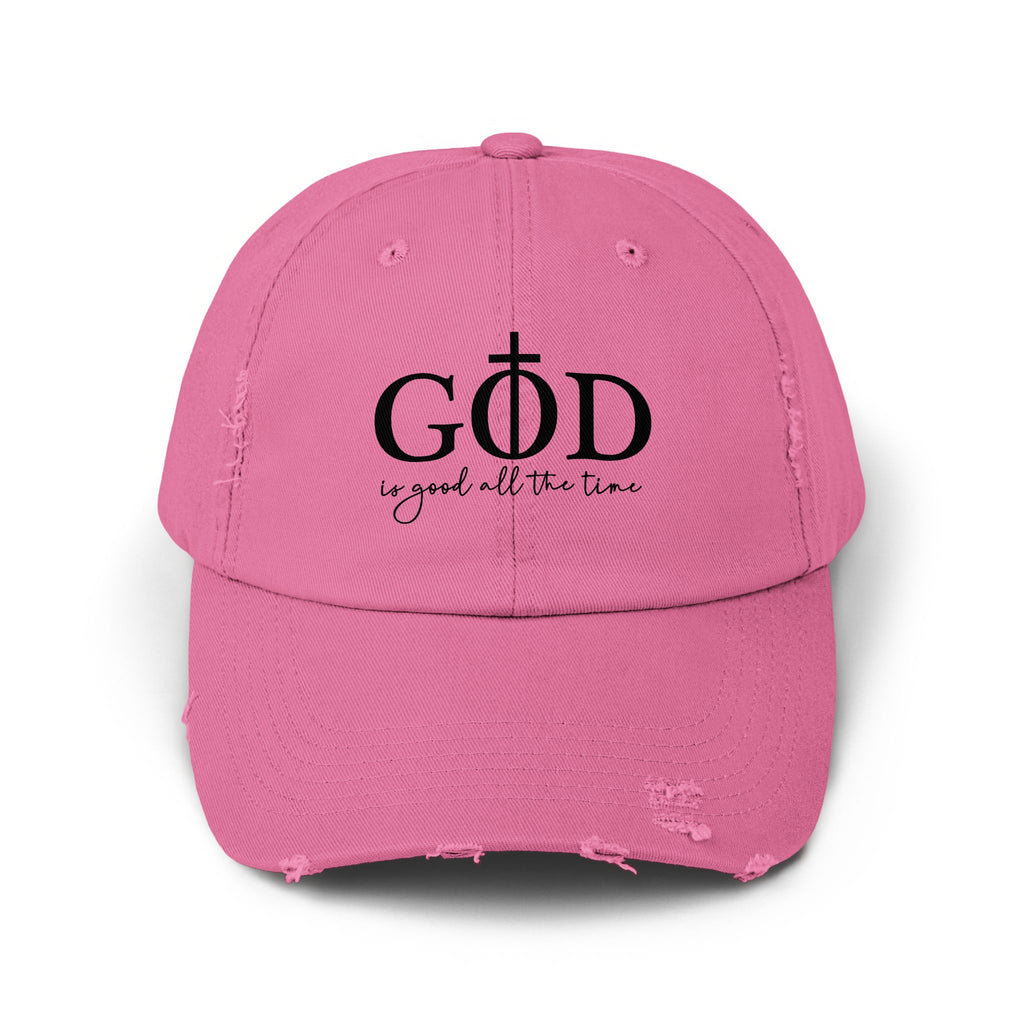 Distressed pink baseball cap with "GOD is good all the time" text and cross.