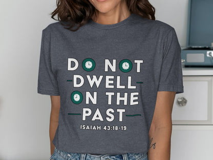 Dark gray t-shirt with "DO NOT DWELL ON THE PAST" and "ISAIAH 43:18-19" text.