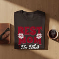 Dark t-shirt with red "BEST MOM In The" text and white flowers.