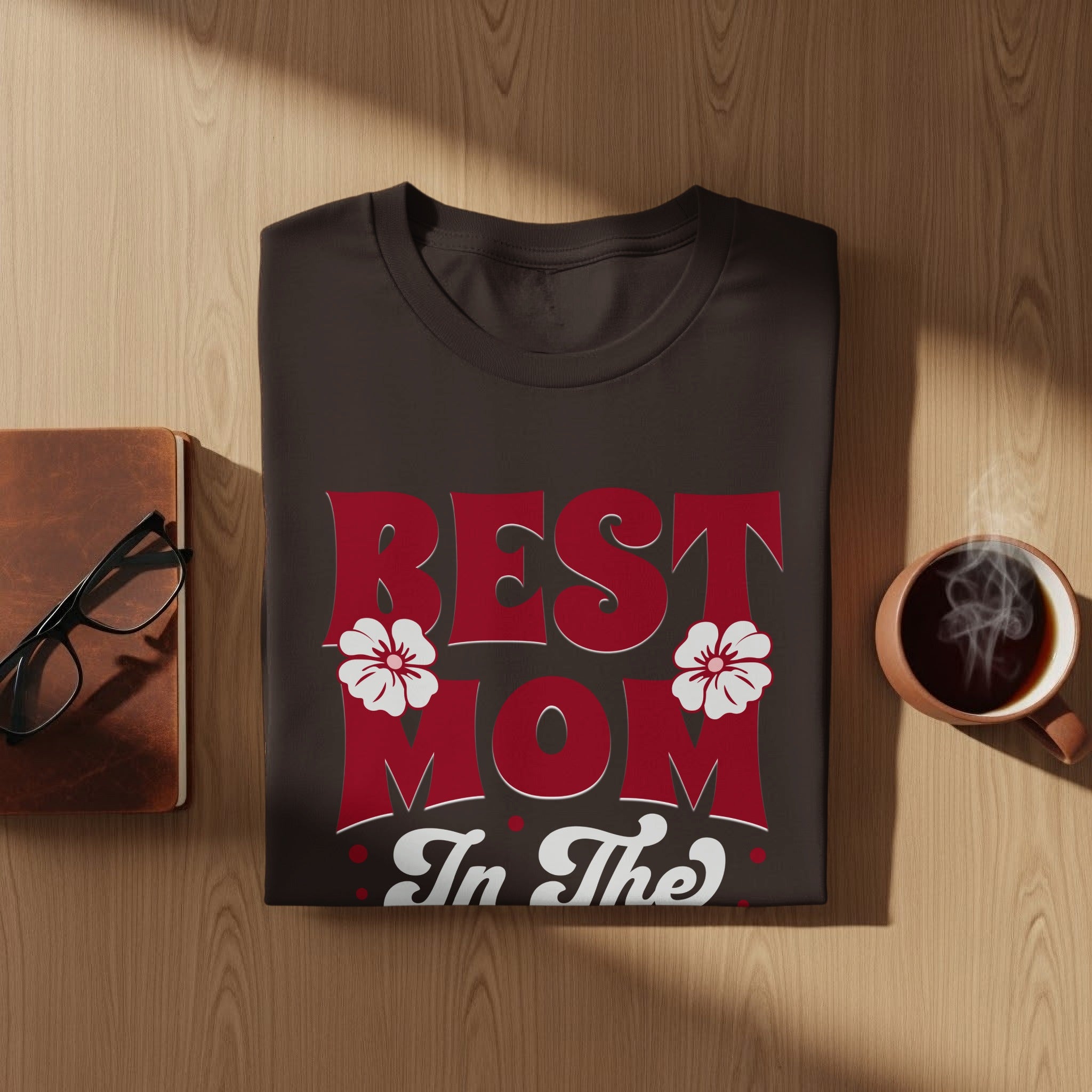 Dark t-shirt with red "BEST MOM In The" text and white flowers.