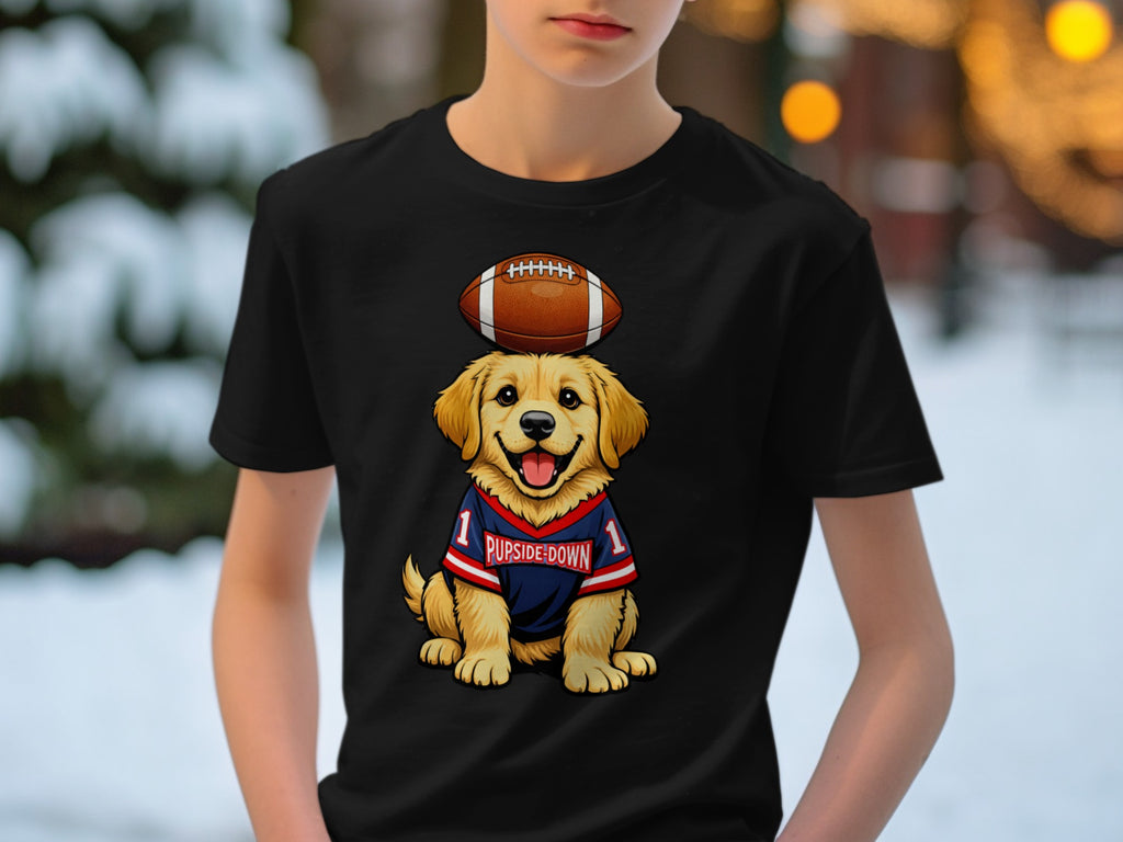Golden retriever puppy wearing a football jersey with "PUPSIDE-DOWN" and an American football on its head.