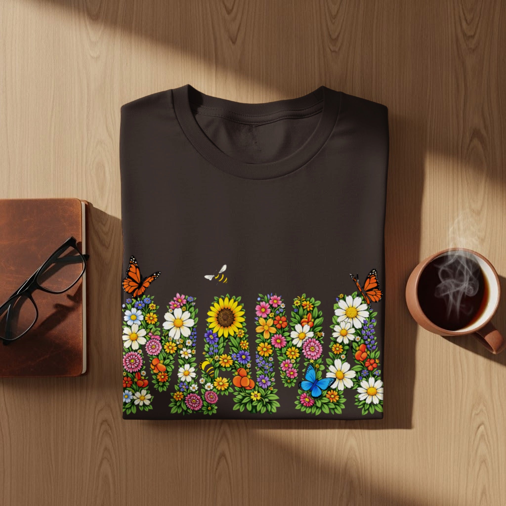 Dark t-shirt with a colorful floral design and "Mama" text, featuring butterflies and a bee.
