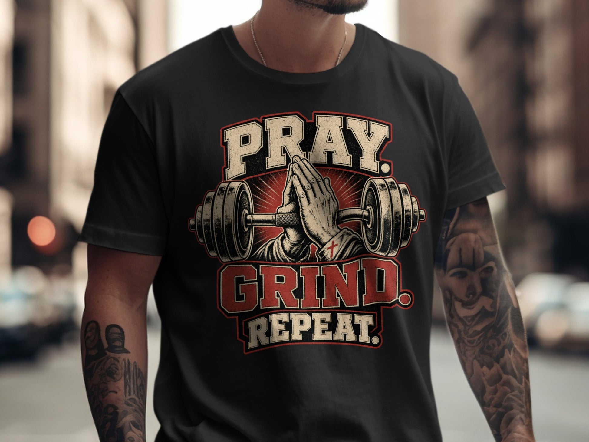 Black t-shirt with Pray. Grind. Repeat. text and praying hands between dumbbells.
