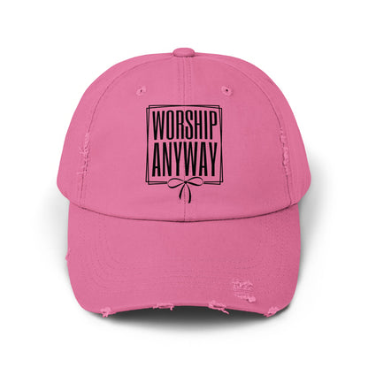 Pink distressed baseball cap with black text "WORSHIP ANYWAY" inside a box.