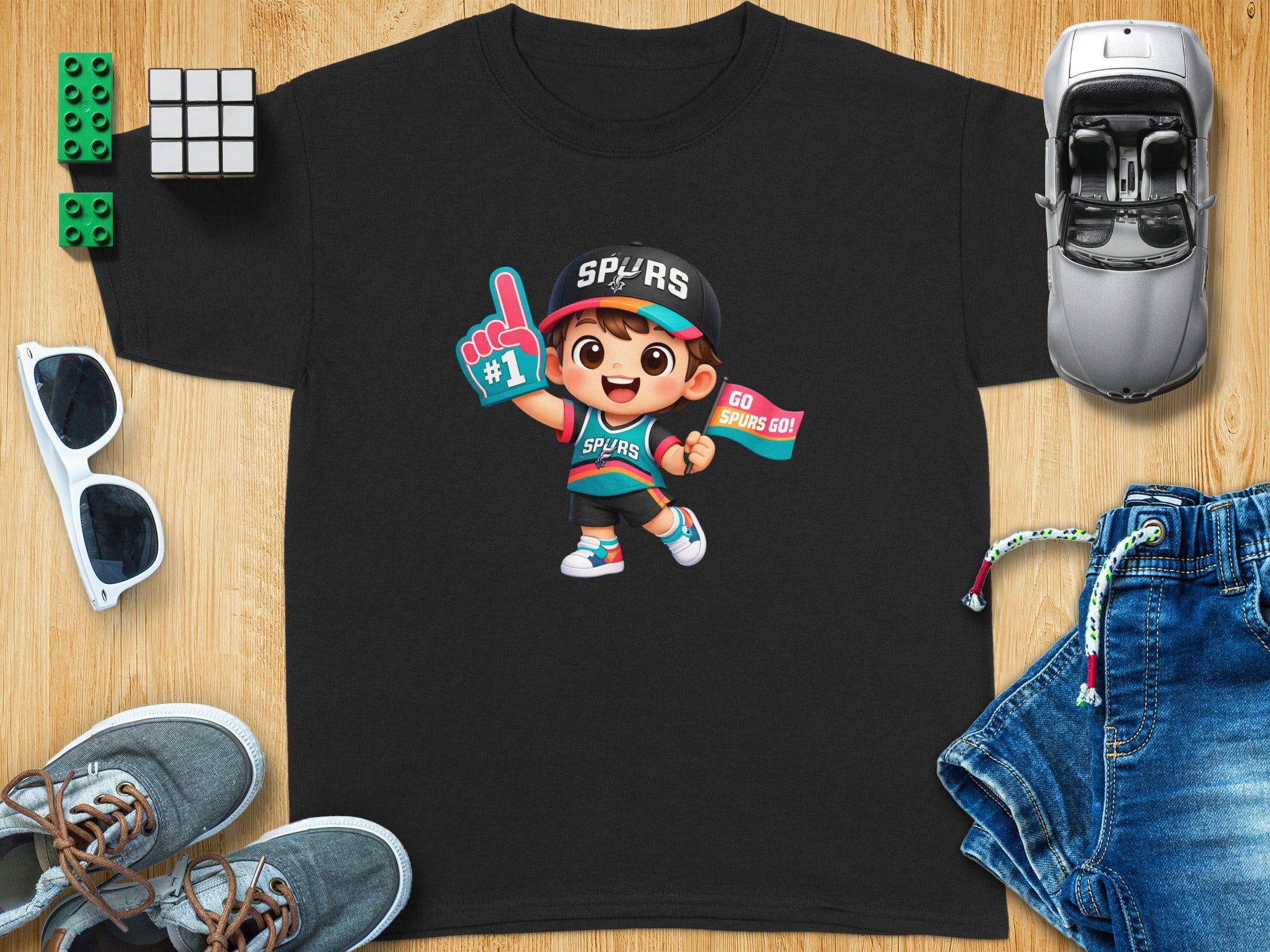 Black t-shirt with cartoon boy in Spurs gear holding a #1 foam finger.