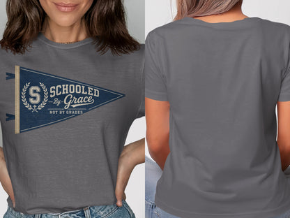 Grey t-shirt with blue pennant graphic: "Schooled by Grace, Not by Grades".