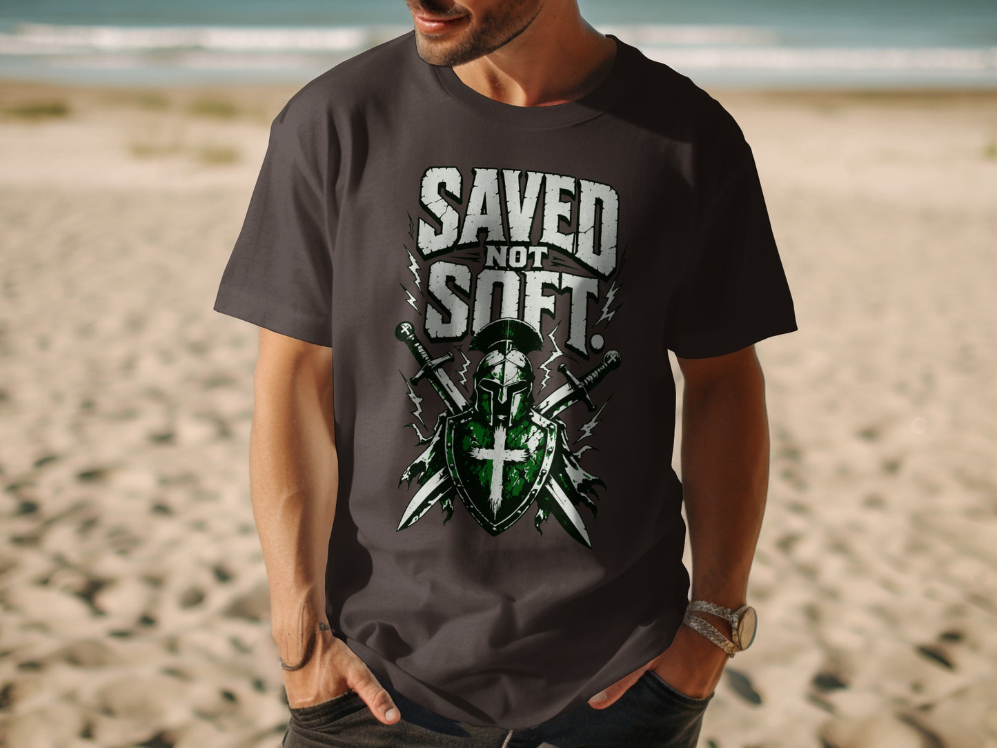 Dark t-shirt with "SAVED NOT SOFT" slogan over knight's helmet and crossed swords.