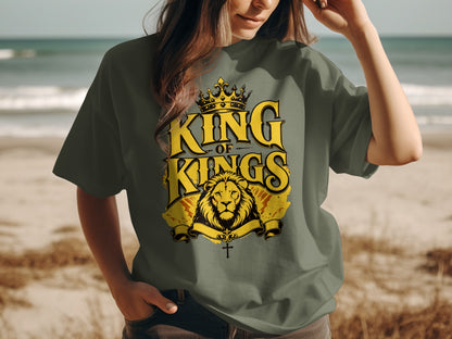 Green t-shirt with yellow "King of Kings" text, lion, and cross graphic.