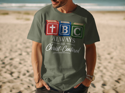 TBC blocks with cross, B, C and text "Always Be Christ-Centered" on shirt.