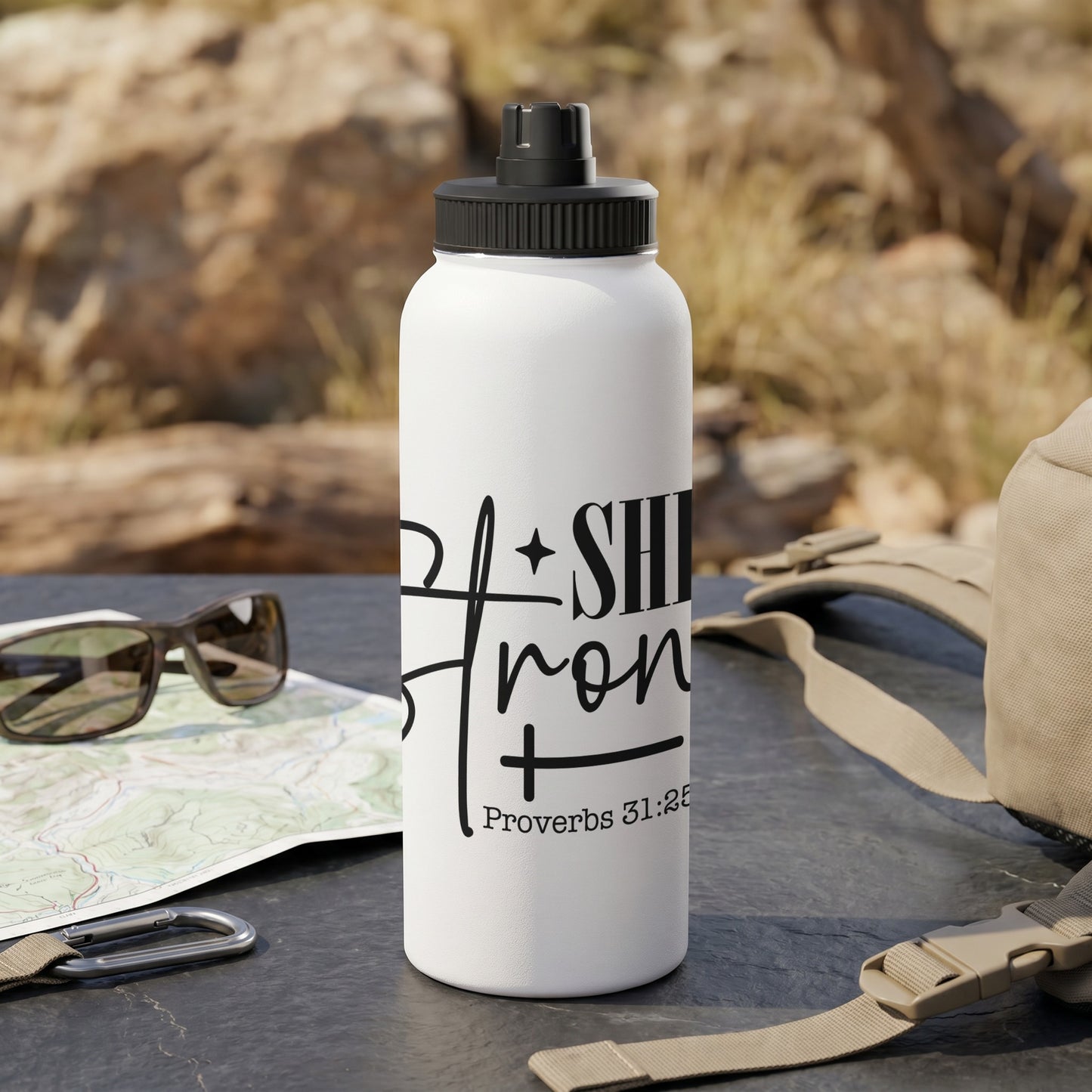 White water bottle with black text reading "She is Strong" and "Proverbs 31:25".
