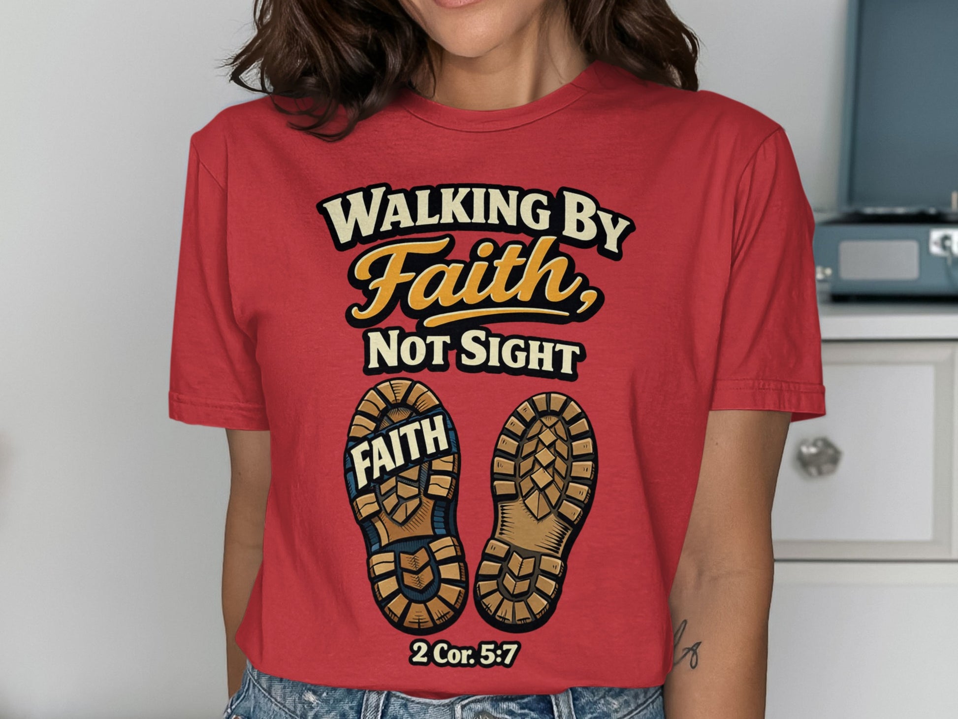 Red t-shirt with "Walking by Faith, Not Sight" and boot soles with "FAITH" and a Bible verse.