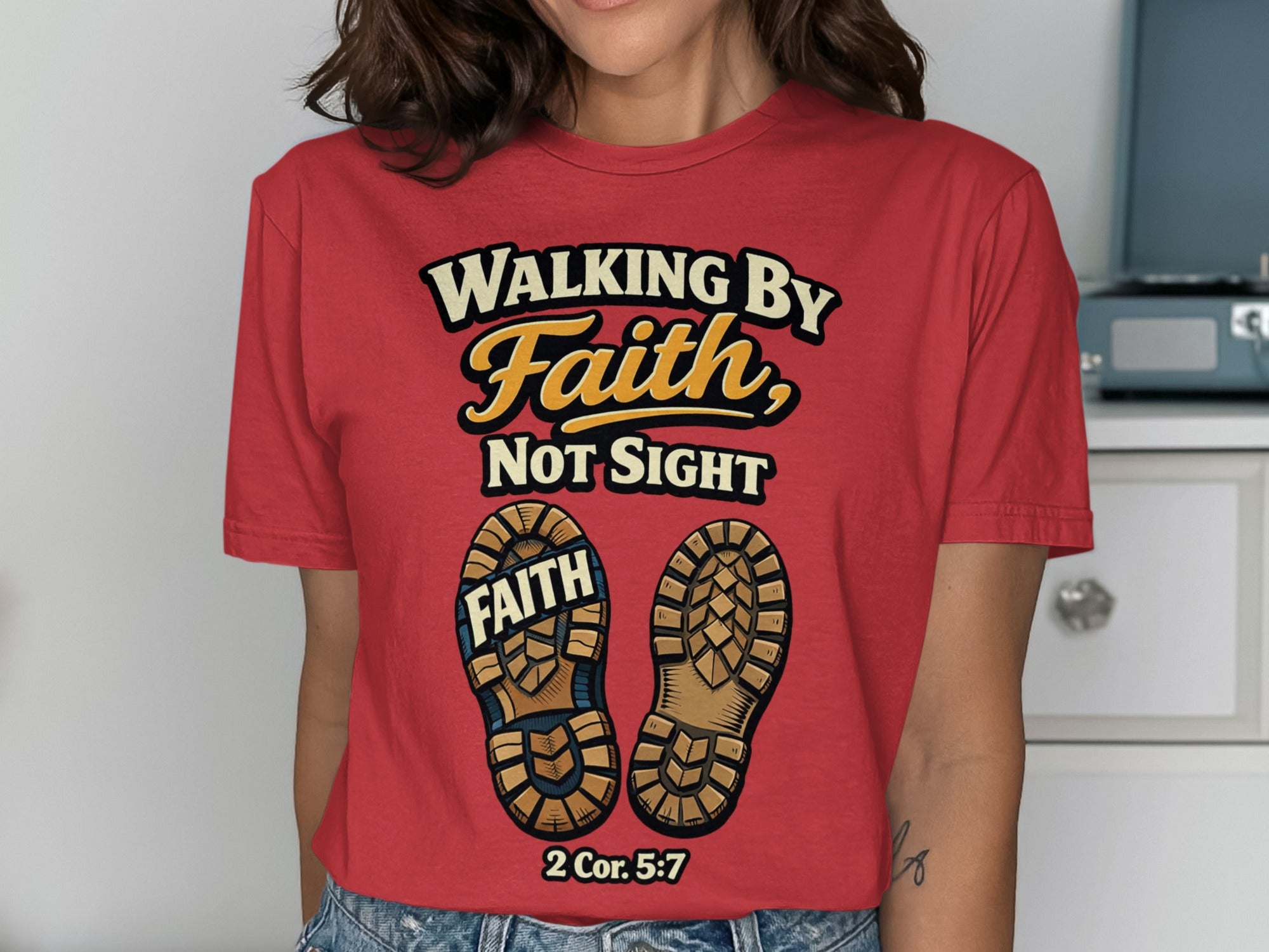 Red t-shirt with "Walking by Faith, Not Sight" and boot soles with "FAITH" and a Bible verse.