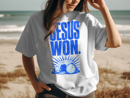 White t-shirt with blue "JESUS WON" text and Easter tomb graphic.