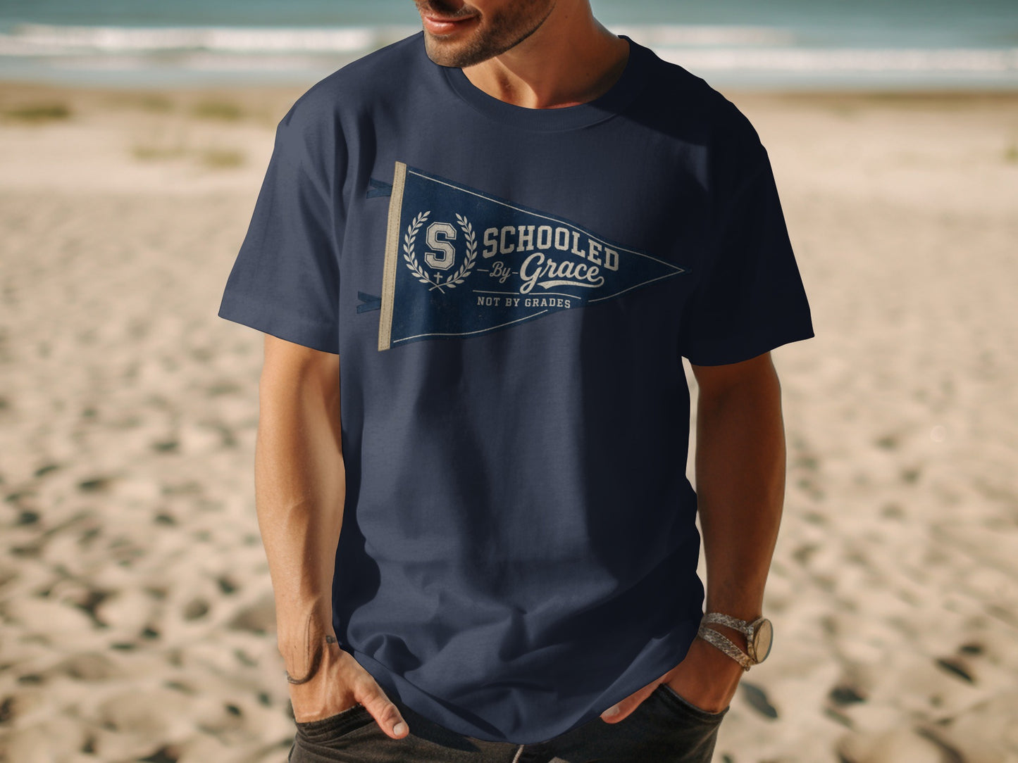 Navy t-shirt with "Schooled by Grace, Not by Grades" pennant graphic.
