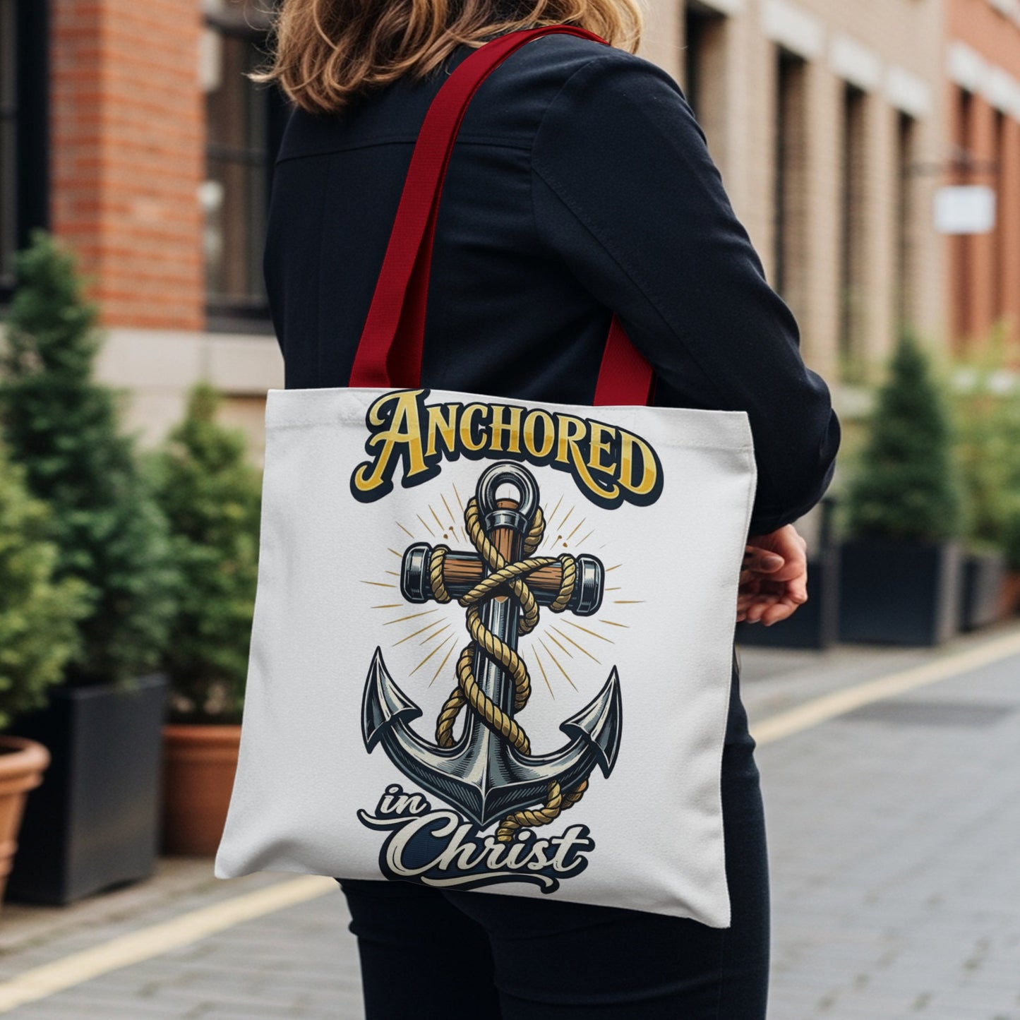 Tote bag with anchor graphic and text "Anchored in Christ"