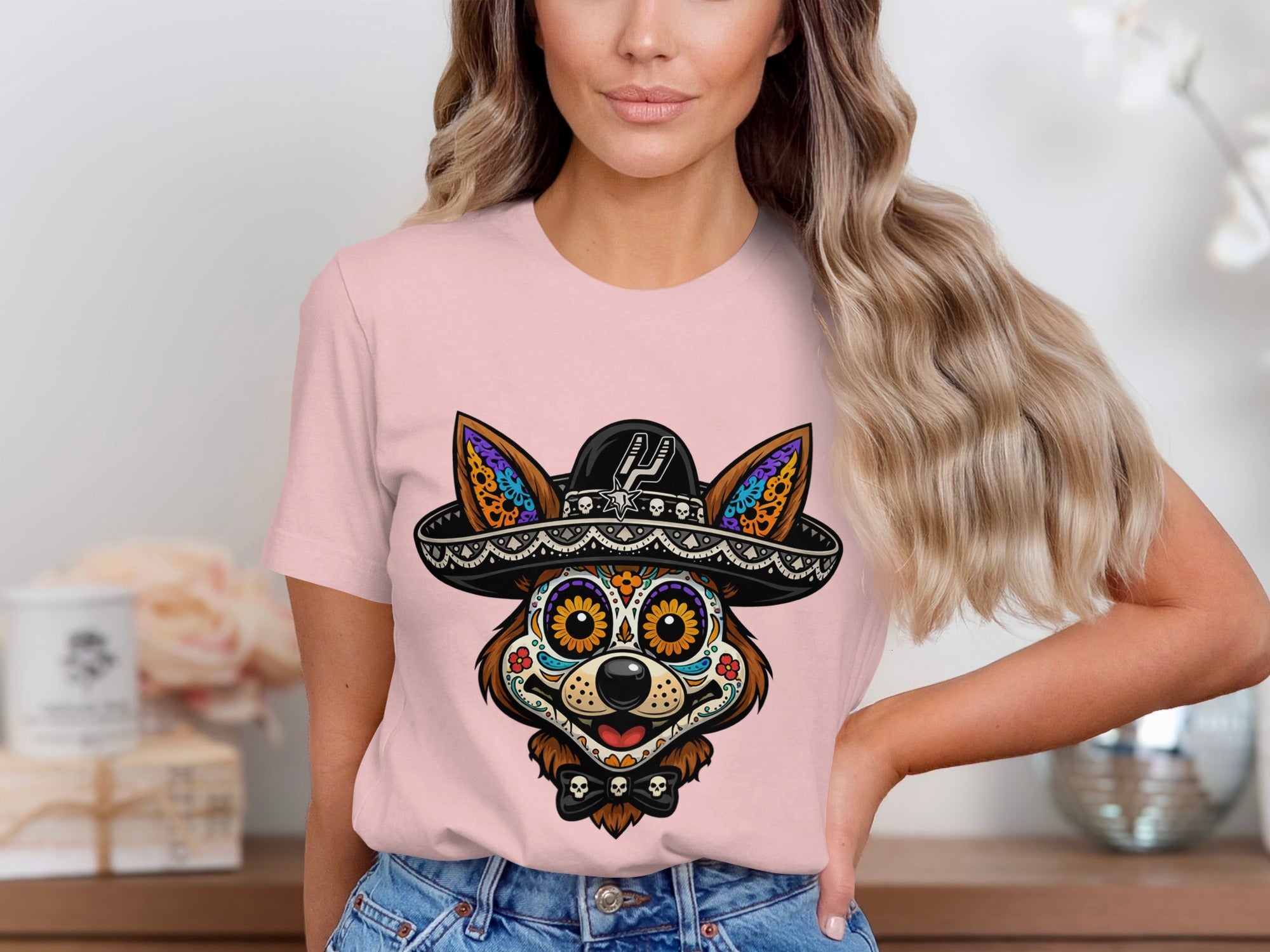 Fox wearing a sombrero and Day of the Dead face paint, on pink t-shirt.