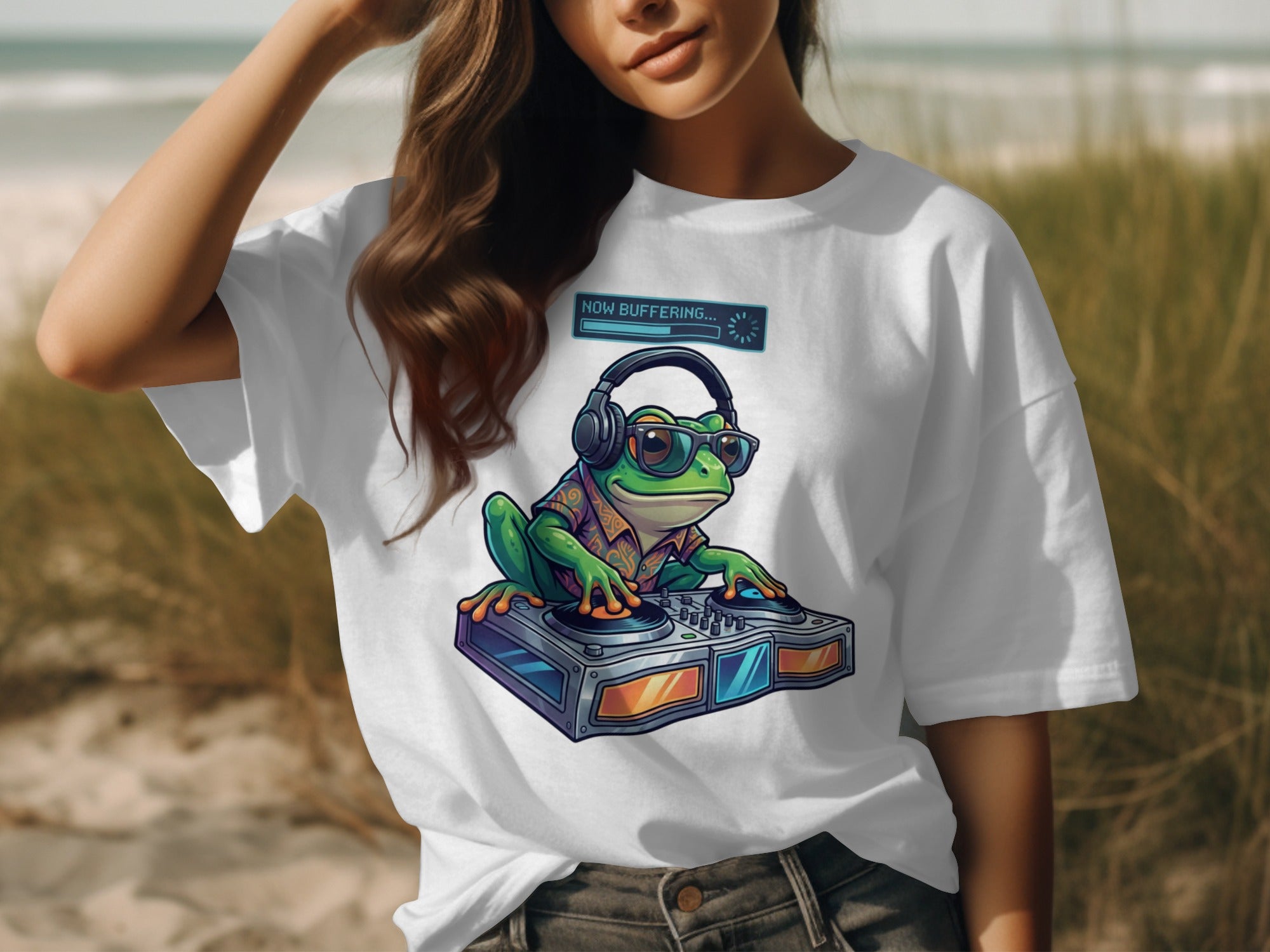 White t-shirt with illustration of frog DJ wearing headphones and sunglasses, text "NOW BUFFERING...".