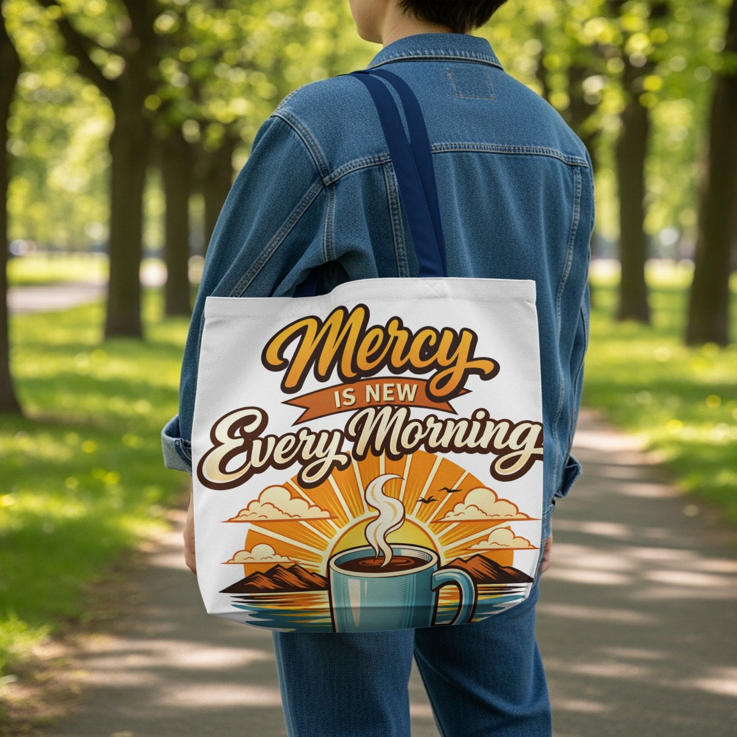 Graphic tote bag with "Mercy is New Every Morning" text and coffee cup sunrise design.