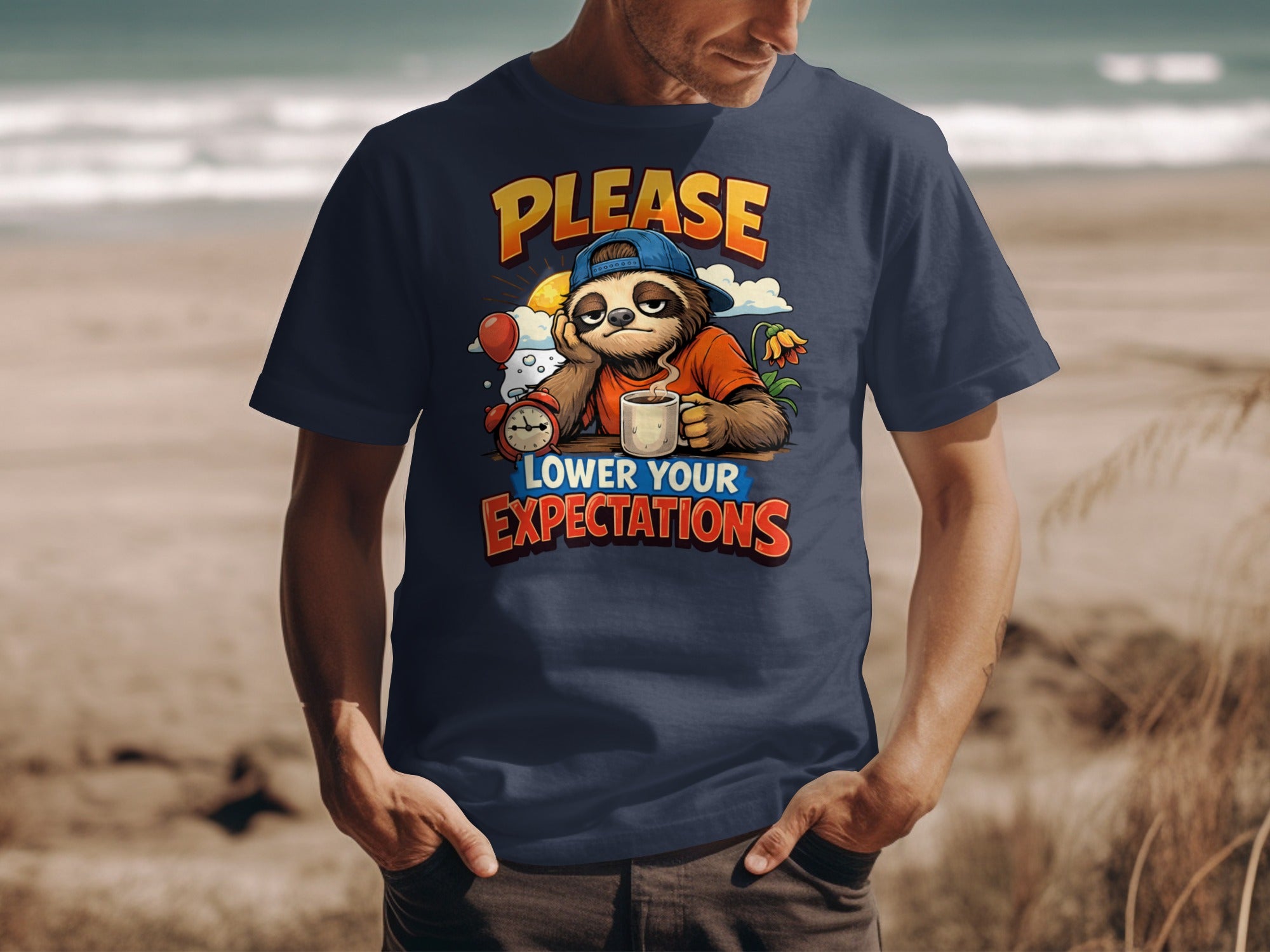 Navy t-shirt with sloth graphic, coffee, alarm, and text "PLEASE LOWER YOUR EXPECTATIONS".