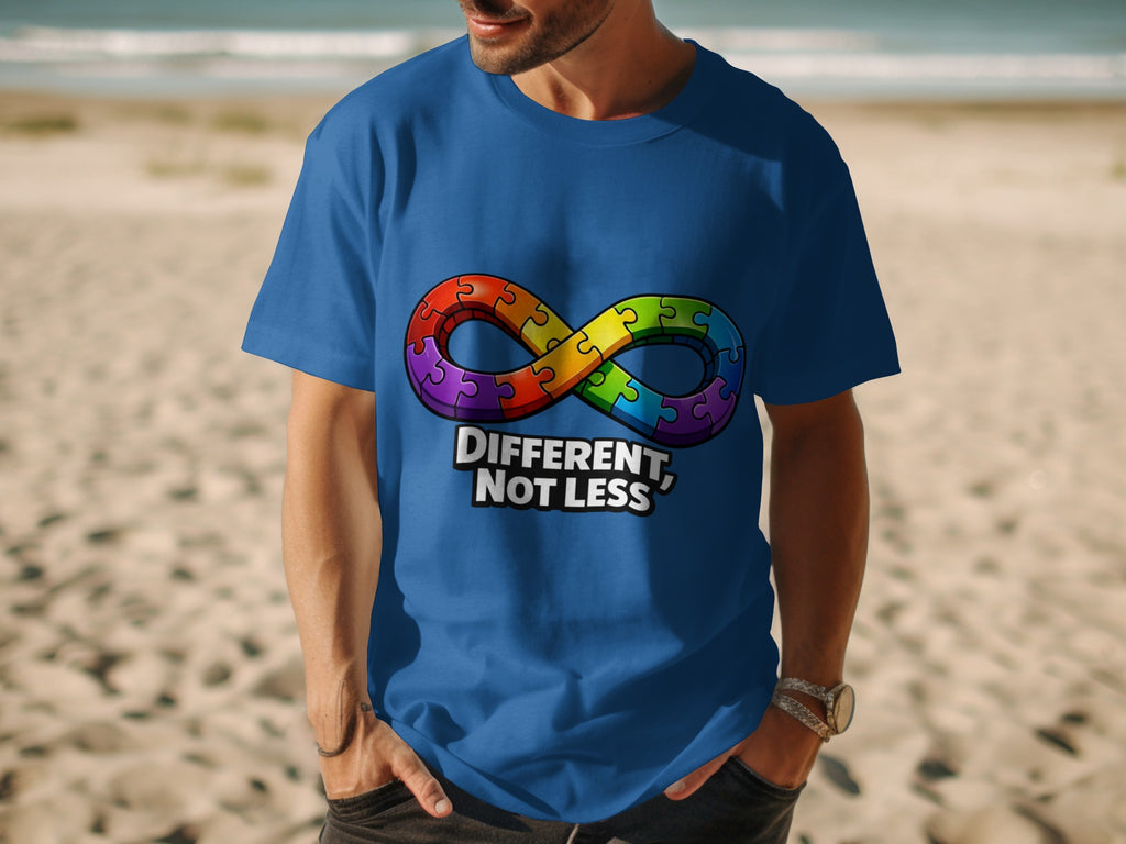 Blue t-shirt with rainbow infinity puzzle symbol and text "DIFFERENT, NOT LESS".