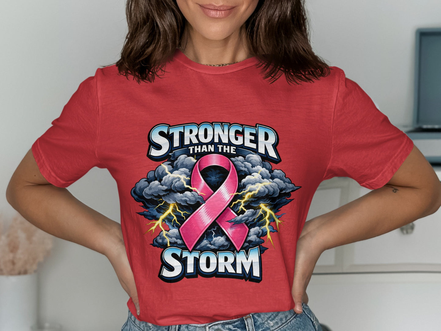 Red t-shirt with pink ribbon graphic and text "Stronger Than The Storm".