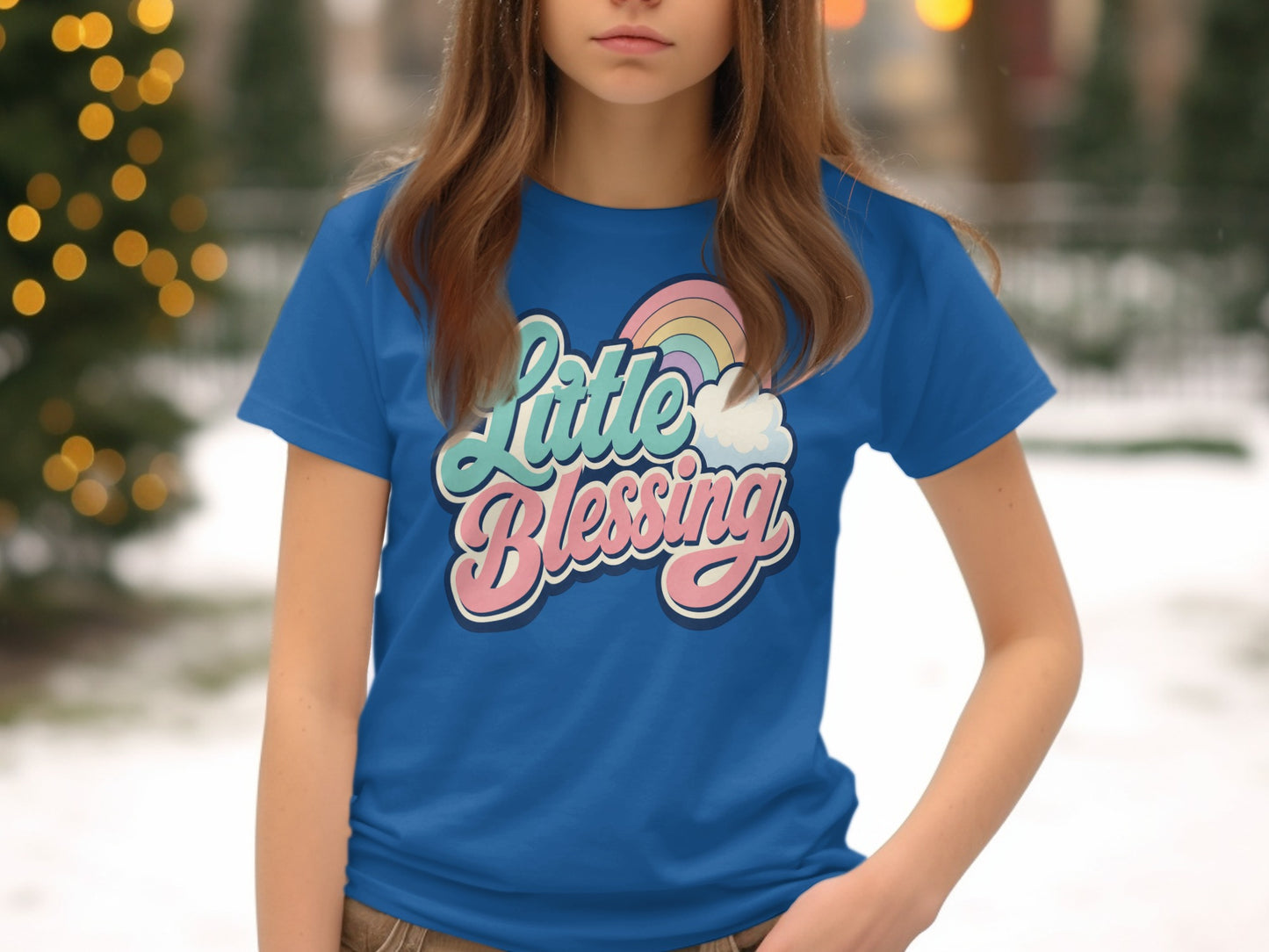 Blue t-shirt with pastel rainbow and clouds graphic saying "Little Blessing".