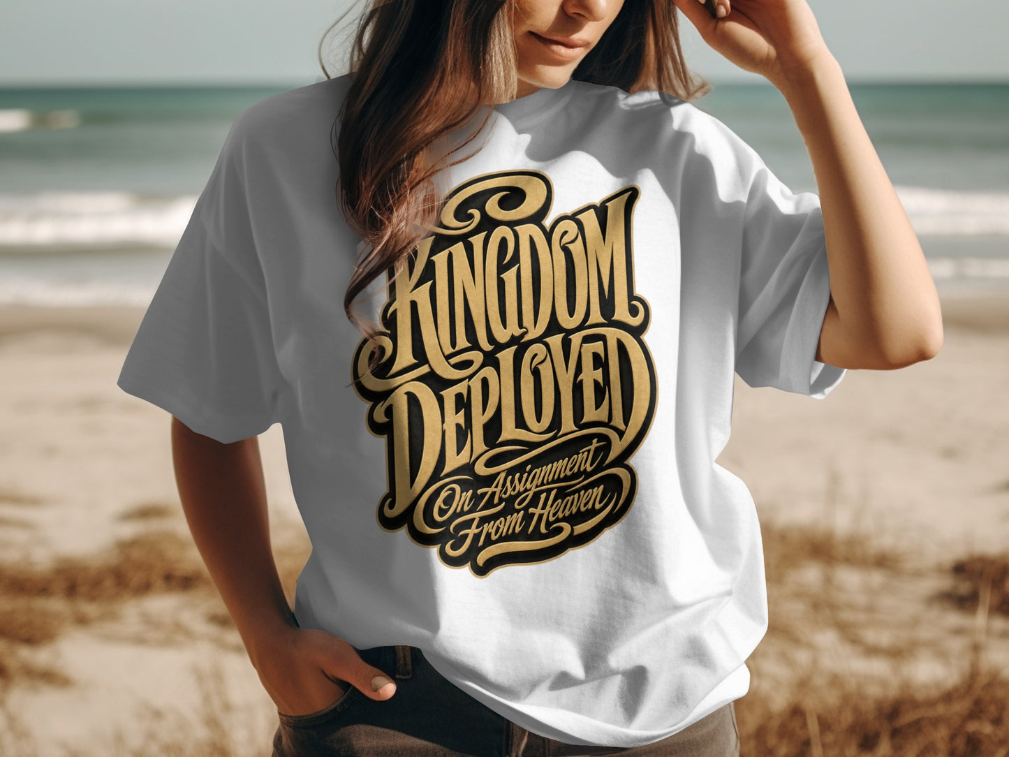 White t-shirt with bold gold text reading "KINGDOM DEPLOYED On Assignment From Heaven".