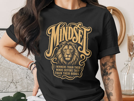 Black t-shirt with "MINDSET" and a lion, text reads "WINNERS TRAIN THEIR MINDS BEFORE THEY TRAIN BODIES."