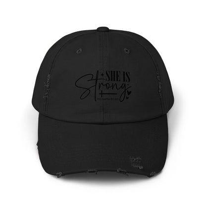 Distressed black baseball cap with "She is Strong" text and "Proverbs 31:25."