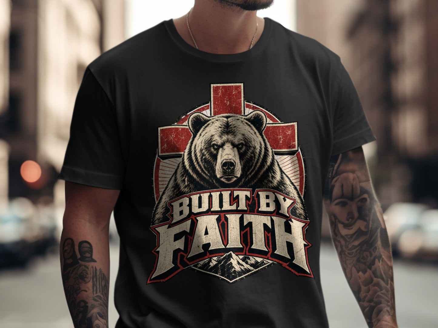 Black t-shirt with a bear, red cross, and "Built by Faith" text design.