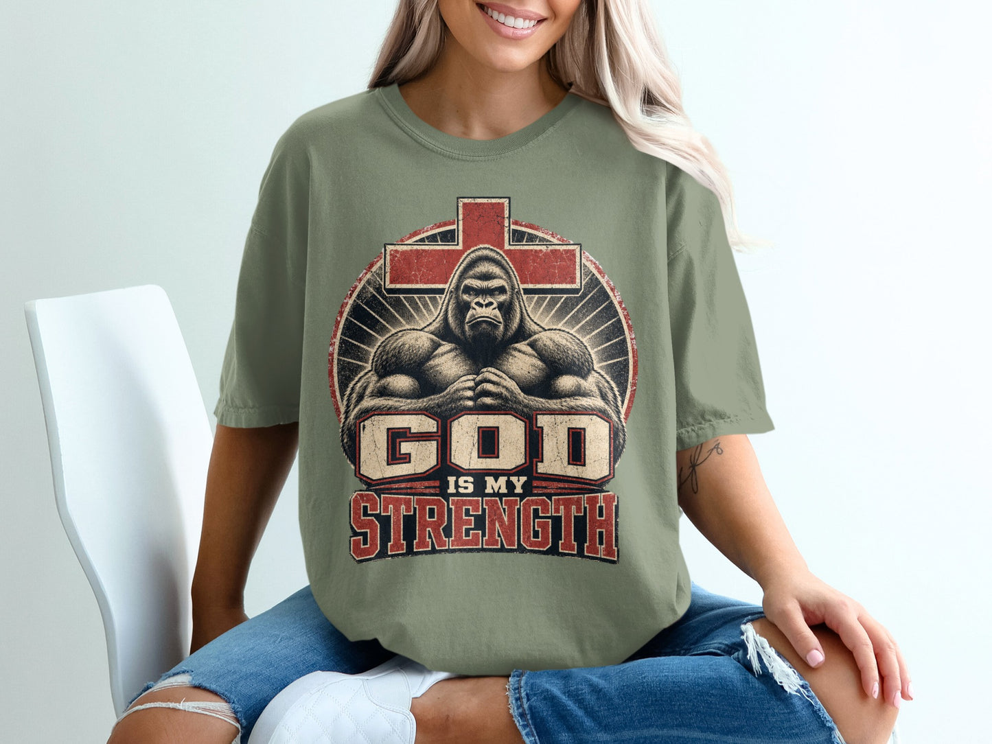 T-shirt with graphic of gorilla, cross, and text "God is My Strength."