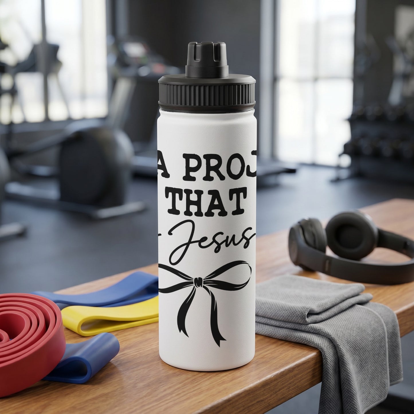 White water bottle with black text and bow, gym equipment background.