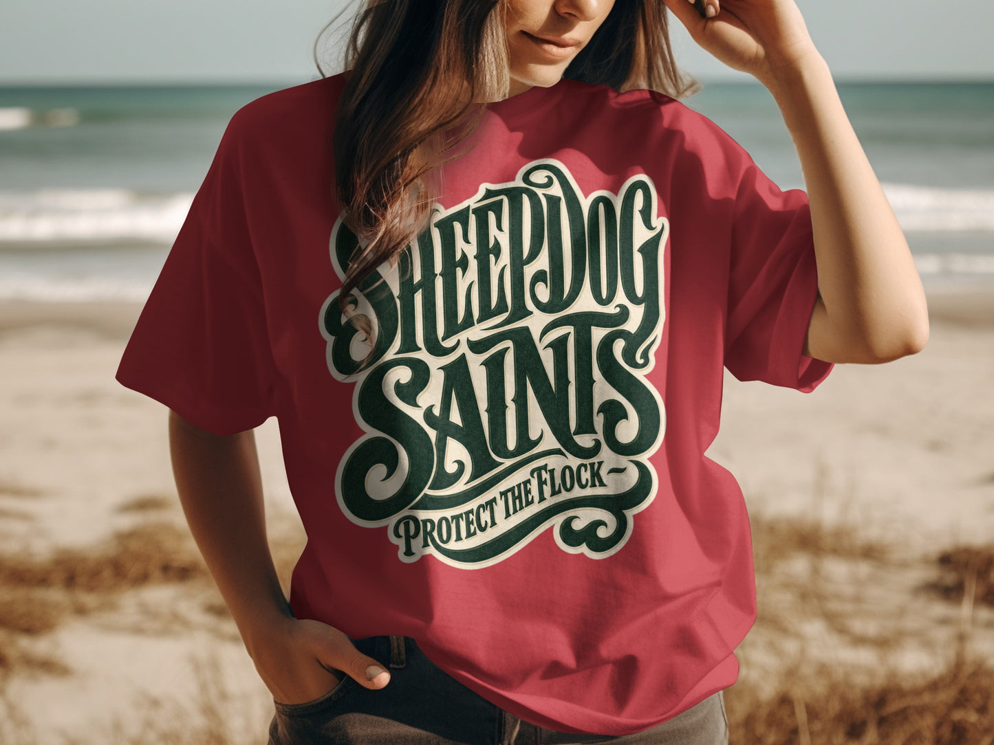 Red t-shirt with "SHEEPDOG SAINTS PROTECT THE FLOCK" text on chest.