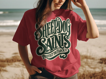 Red t-shirt with "SHEEPDOG SAINTS PROTECT THE FLOCK" text on chest.