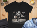 Black v-neck t-shirt featuring a raccoon in football gear running with a ball.