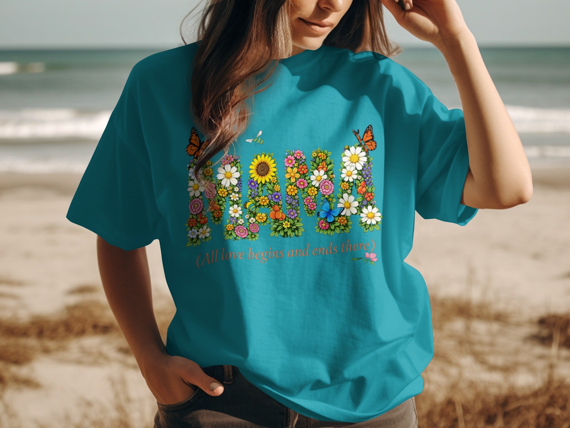 Teal t-shirt with "MOM" written in flowers, butterflies and a bee.