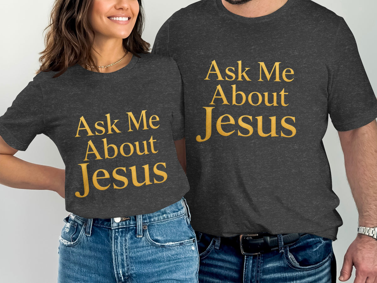 Two people wearing dark grey t-shirts with gold text that reads "Ask Me About Jesus."