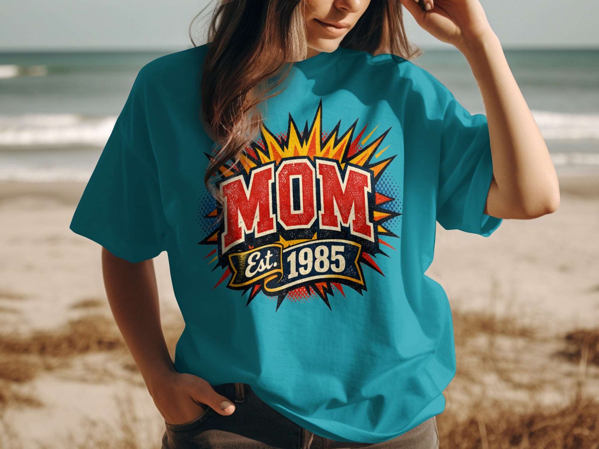 Turquoise t-shirt with vintage "MOM Est. 1985" graphic with starburst background
