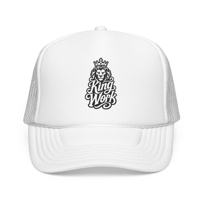 White trucker hat with a black embroidered lion wearing a crown and the words "King Work".