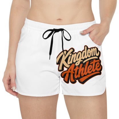 White athletic shorts with "Kingdom Athlete" text graphic in orange and tan.