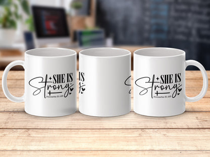 Three white mugs with "SHE IS STRONG Proverbs 31:25" text.