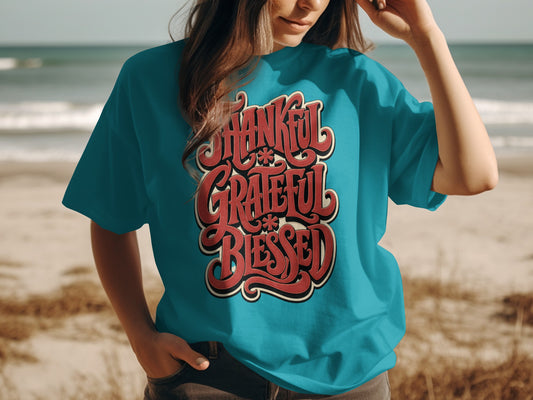 Turquoise t-shirt with "Thankful Grateful Blessed" text in red lettering.