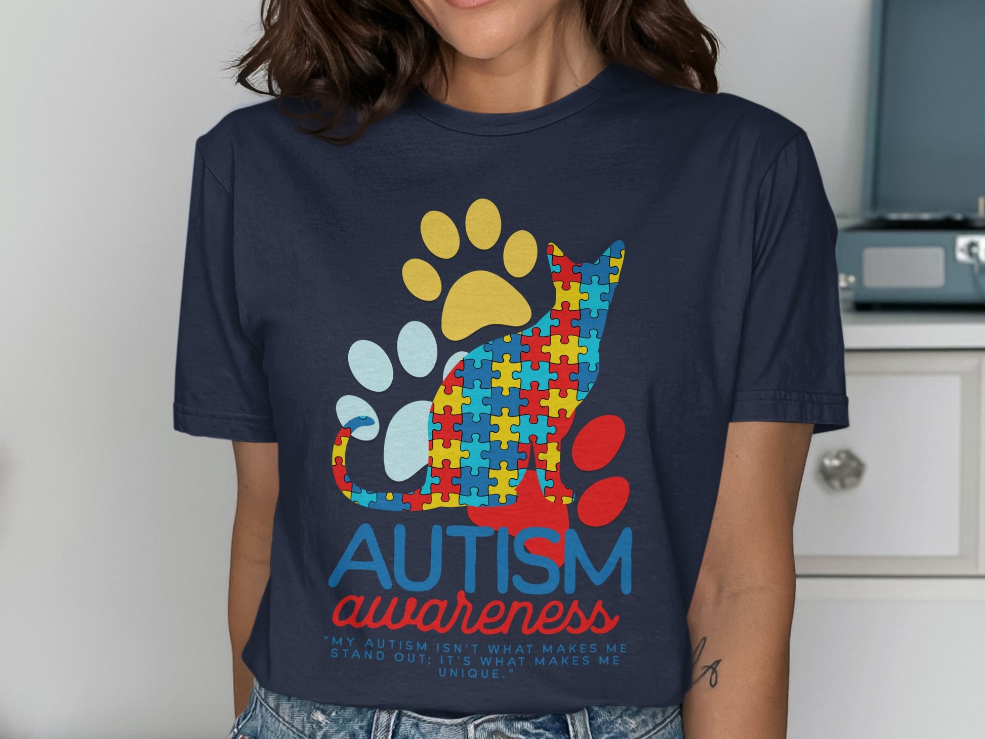 Navy t-shirt with autism awareness cat design and text.