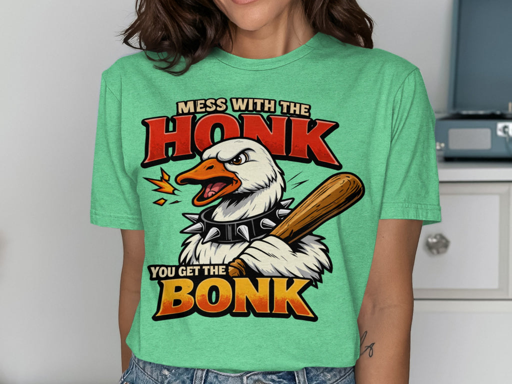 Green graphic tee with text "MESS WITH THE HONK YOU GET THE BONK" and a cartoon goose.
